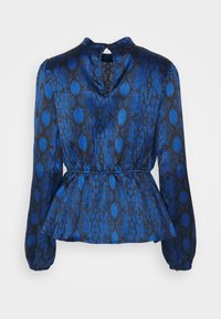 Blusa blu con fantasia, a maniche lunghe, con vita a peplum, scollatura rotonda e dettaglio a chiave sulla schiena. Tessuto morbido con design a stampa serpente.