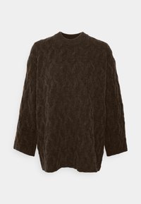 Brauner Strickpullover mit langen Ärmeln, runder Ausschnitt und strukturiertem Oberflächenmuster. Der Stoff wirkt weich und warm.