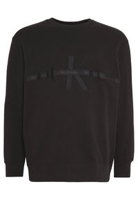 Czarna bluza bawełniana z długimi rękawami. Posiada teksturowane logo i poziomy pasek na wysokości klatki piersiowej. Klasyczny krój.