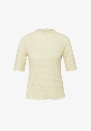 Haut en maille à manches courtes de couleur crème avec un motif en nid d'abeille texturé, un col haut et des bords légèrement festonnés aux manches et à l'ourlet.