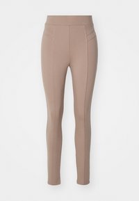 Ljusbruna leggings med en slät textur, hög midja och minimala sömnadsdetaljer längs sidorna. Sittande siluett.