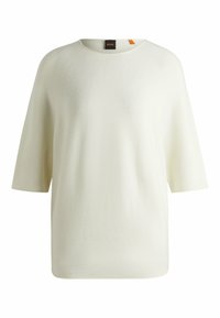 Cream short-sleeve sweater made of textured fabric, featuring a round neck and a subtle seam detail. Tag with brand label visible at neckline.
