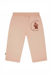 Helle rosa Baumwollhosen mit einem elastischen Bund, versehen mit einem braunen Affenmotiv und Text am linken Bein, glatte Textur und gerader Schnitt.