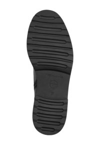 Semelle de chaussure en caoutchouc noir, avec des rainures horizontales, une surface texturée et un logo circulaire. Taille indiquée : 37.