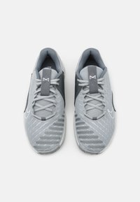 Gray athletic shoes with a textured mesh upper, contrasting gray accents, light gray laces, and a pull tab at the heel.