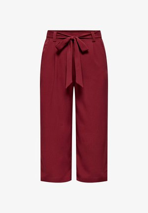 Bordo krāsas kulotes ar platām kājām, auduma jostu un loku detaļu viduklī, ar gludu virsmu un bez redzamām rakstu detaļām.