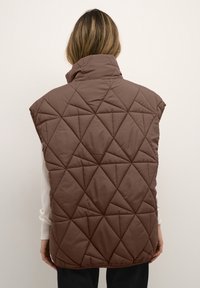 Brązowa pikowana kamizelka z wysokim kołnierzem i diamentowym wzorem. Bezrękawnik, lekki materiał. Gładka faktura, luźny krój.