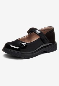 Black patent leather Mary Jane shoe with rounded toe, hook-and-loop strap, cushioned interior, and thick textured rubber sole on white background.