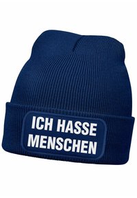 Navy knit beanie with a folded cuff, featuring a white rectangular patch displaying the text "ICH HASSE MENSCHEN" in bold font.