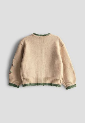 Strickpullover in Creme mit grünen Rippbündchen und Kragen. Enthält leichte Blumenstickerei an den Ärmeln, strukturierten Stoff. Lockere Passform.