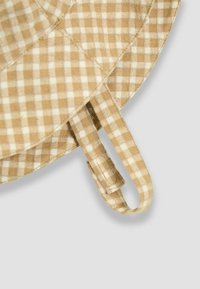 Beez checkered kangas pehmea tekstuuriga, ümmargune ja lühikese aasaga rihmaga kinnitamiseks.