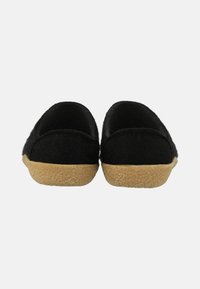 Black felt slippers with a soft, textured upper, rounded shape, and a light brown rubber sole. Designed for indoor use.