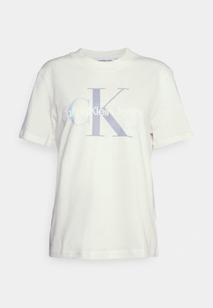 White cotton t-shirt featuring the text "Calvin Klein Jeans" with a large "CK" logo in light blue. Classic crew neck and short sleeves.