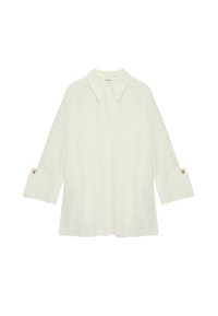 Lichtcrème geknoopte shirt met lange mouwen, voorzien van knoopmanchetten. Gemaakt van een soepele stof met een relaxte pasvorm.