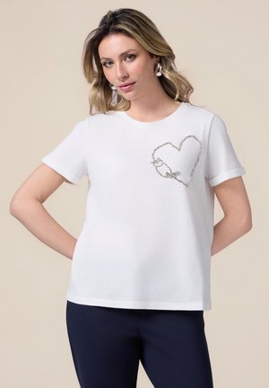 Weißes T-Shirt mit kurzen Ärmeln aus weichem Stoff, mit einem dekorativen silbernen Herzdesign im linken Brustbereich.