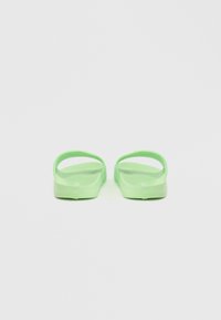 Green flip-flops with a flat sole and rounded straps. Made of lightweight material, featuring a textured footbed for grip.