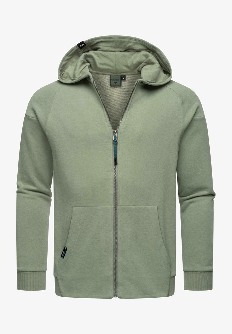 Felpa verde chiaro con zip realizzata in tessuto morbido, dotata di cappuccio, tasche frontali e dettagli in zip a contrasto. Maniche e orlo a coste.