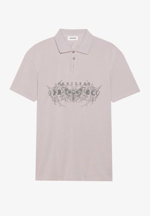Lys mauve polo skjorte med en struktureret finish, der har et sort grafisk design af møl og ordet "Punished" på tværs af brystet.