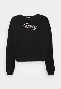 Felpa nera corta realizzata in morbido tessuto, con maniche lunghe e scollo a girocollo, caratterizzata dal logo 'Roxy' ricamato in rosa sulla parte anteriore.