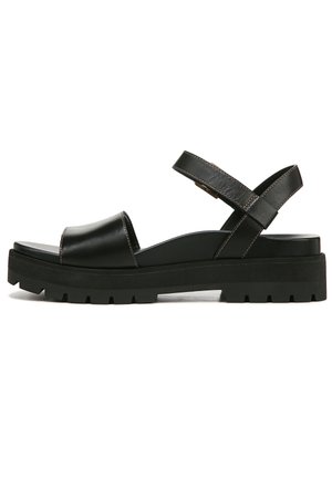 Black leather sandal featuring a wide strap across the toes, a crisscross ankle strap, and a thick rubber platform sole with treads.