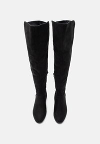 Knee-high black suede boots with a fitted design, featuring a smooth texture and minimalistic silhouette. Side zipper for easy wear.