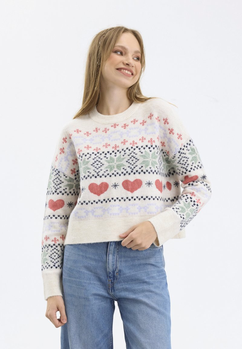 Knit sweater with a cream base, featuring colorful patterns including hearts, snowflakes, and flowers. Long sleeves and a cropped design.