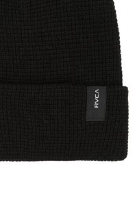 Black knitted beanie made of textured fabric with a folded cuff. Features a small rectangular brand tag in black and white.