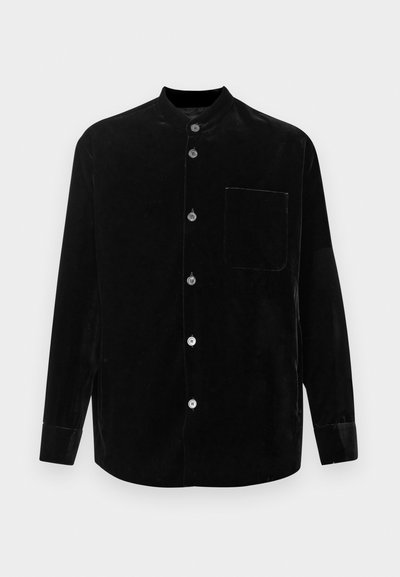 Black velvet shirt with a mandarin collar, long sleeves, five button front closure, and a single chest pocket. Soft texture and smooth finish.