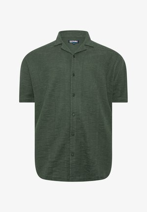 Chemise à manches courtes verte foncée texturée avec col et boutons, étiquetée "BADRHINO" taille 4XL, présentée sur un fond blanc.