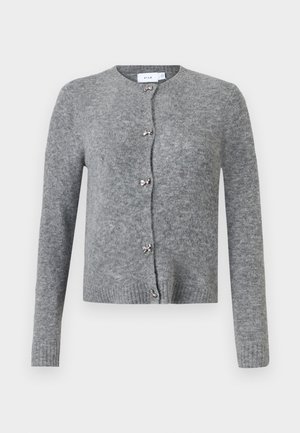 Cardigan en tricot gris avec un col rond, sept boutons et de petits accents en forme de nœud. Doté de manches longues et de poignets et d'un ourlet côtelés.