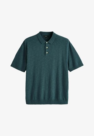 Sötét tengeri zöld rövid ujjú galléros póló három világos színű gombbal és bordázott szegéllyel, fehér háttéren.