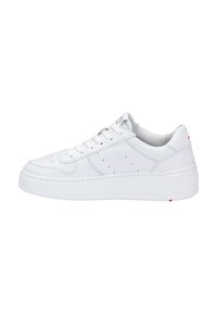 White leather sneaker featuring a thick, textured sole, round toe, perforated details, and flat laces. Red accent near the heel.