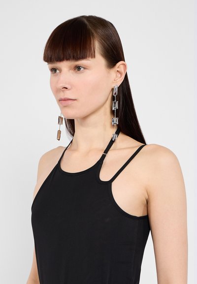Silver-tone drop earrings feature geometric shapes with smooth surfaces and alternating rectangular and square designs, hanging from chain links.