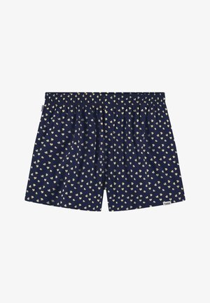 Boxers bleu marine avec des motifs floraux jaunes, taille élastique, coupe ample, tissu doux. Présente une petite étiquette de marque à l'ourlet.