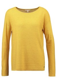 Gelber Pullover mit langen Ärmeln, geripptem Muster, Rundhalsausschnitt und lockerer Passform. Besitzt ein kleines Logo-Detail nahe dem unteren Saum.