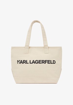 Leinwand-Tragetasche in Beige mit schwarzem "KARL LAGERFELD"-Logo. Verfügt über zwei Stoffgriffe und eine rechteckige Form, geeignet für den täglichen Gebrauch.
