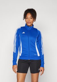 Blue athletic jacket with white stripes, zipper closure, high collar, and Aeroready branding. Pairing with black shorts.