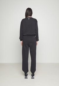 Champion Rochester ELASTIC CUFF PANTS - Treningo apatinė dalis - black