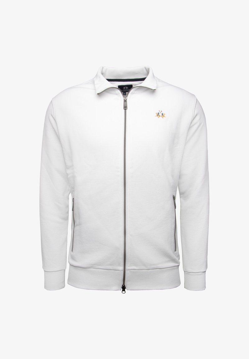 White zip-up sweatshirt with a stand collar, featuring a small embroidered logo and side pockets, made of soft, textured fabric.