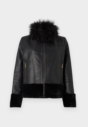 Veste en cuir noire avec col en fourrure douce, poignets et ourlet, dotée d'une fermeture éclair à l'avant et de poches latérales zippées.