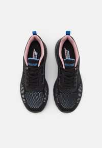 Black athletic shoes with a mesh design, featuring blue and pink accents, round toe, and textured sole for grip. Lace-up style.