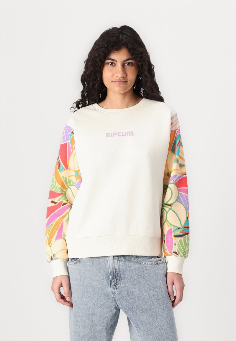 Sudadera crema con mangas de patrón tropical colorido. Presenta un cuello redondo y un logo "RIPCURL" en la parte frontal. Tejido de algodón suave.