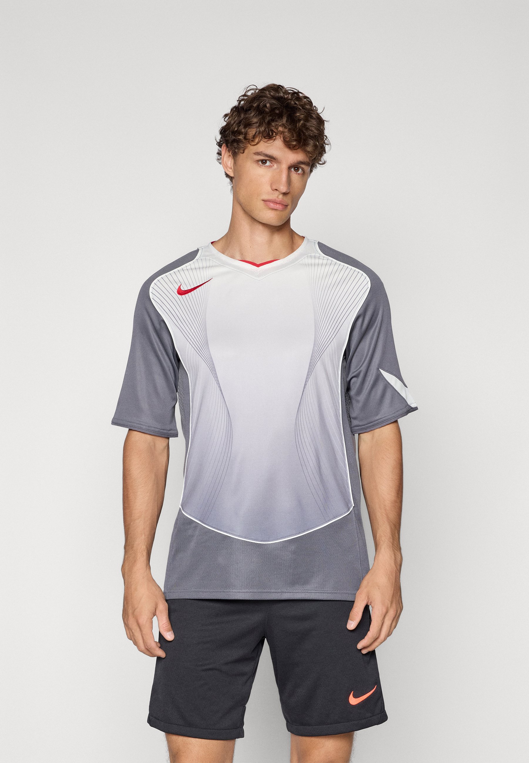 gray and red nike shirt