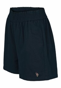 Tummansiniset puuvillahousut, joissa on smokkityylinen vyötärö ja pieni kirjailtu logo alareunan vasemmalla puolella. Klassinen, rento leikkaus.