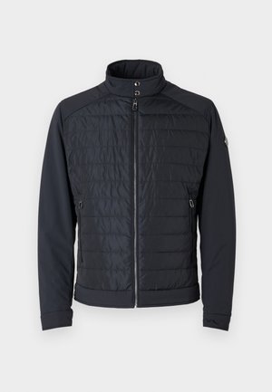 Padded black jacket with stand-up collar and zippered front. Features textured body and smooth sleeves, two zippered side pockets.