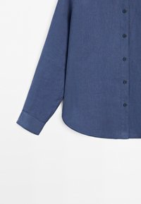 Long-sleeve blue button-up shirt with a classic collar, visible cuffs, and a slightly curved hem on a white background.