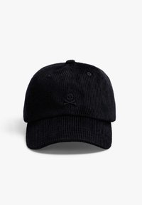 Gorra de béisbol de pana negra con visera curva, tela texturizada y un detalle bordado de calavera y tibias cruzadas en la parte frontal.