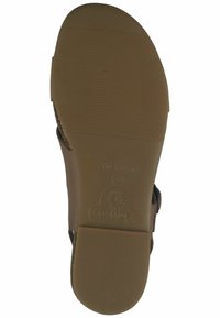 Braune Sandalensohle mit strukturiertem Gummibelag, versehen mit einem gestempelten Logo und Größenangabe. Hergestellt in Spanien, konzipiert für Komfort und Langlebigkeit.