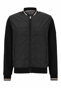 Svart bomberjacka med vadderad framsida, ribbade ärmslut och texturerade ärmar. Har dragkedjeförslutning och randig krage.