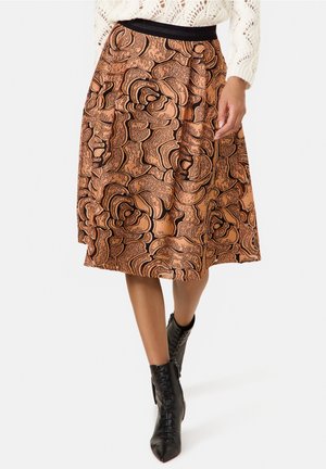 Jupe orange-brun avec un motif abstrait de roses, dotée d'une ceinture noire. Le tissu semble texturé et léger.